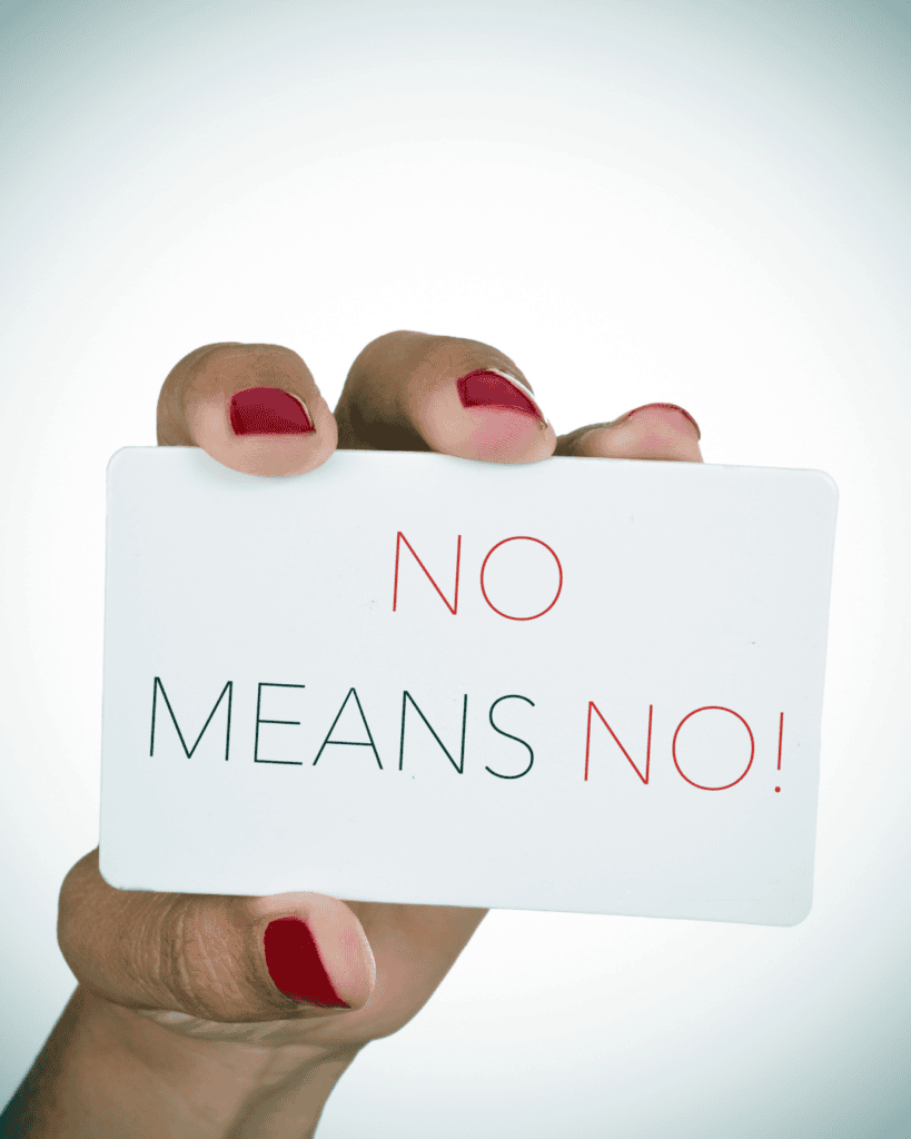 hand holding card that says no means no